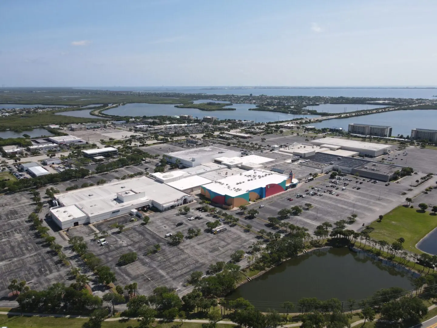 Aerial view of a large shopping mall and surrounding parking areas
